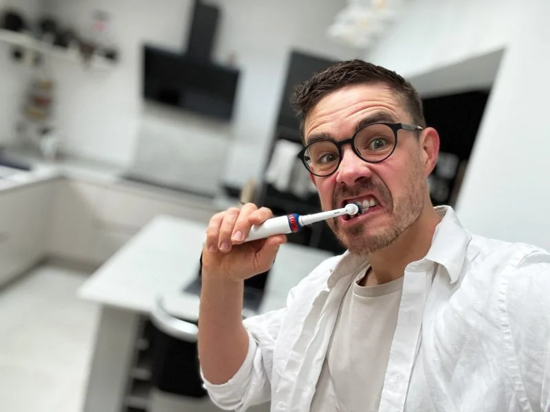 Luke posing with a toothbrush for his SEO for dentists post
