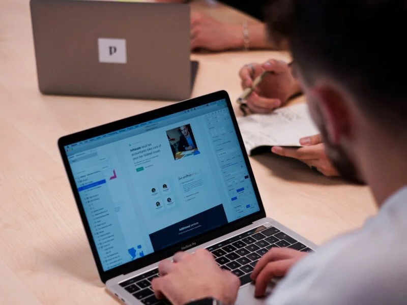 Web designer working at a laptop on a website project