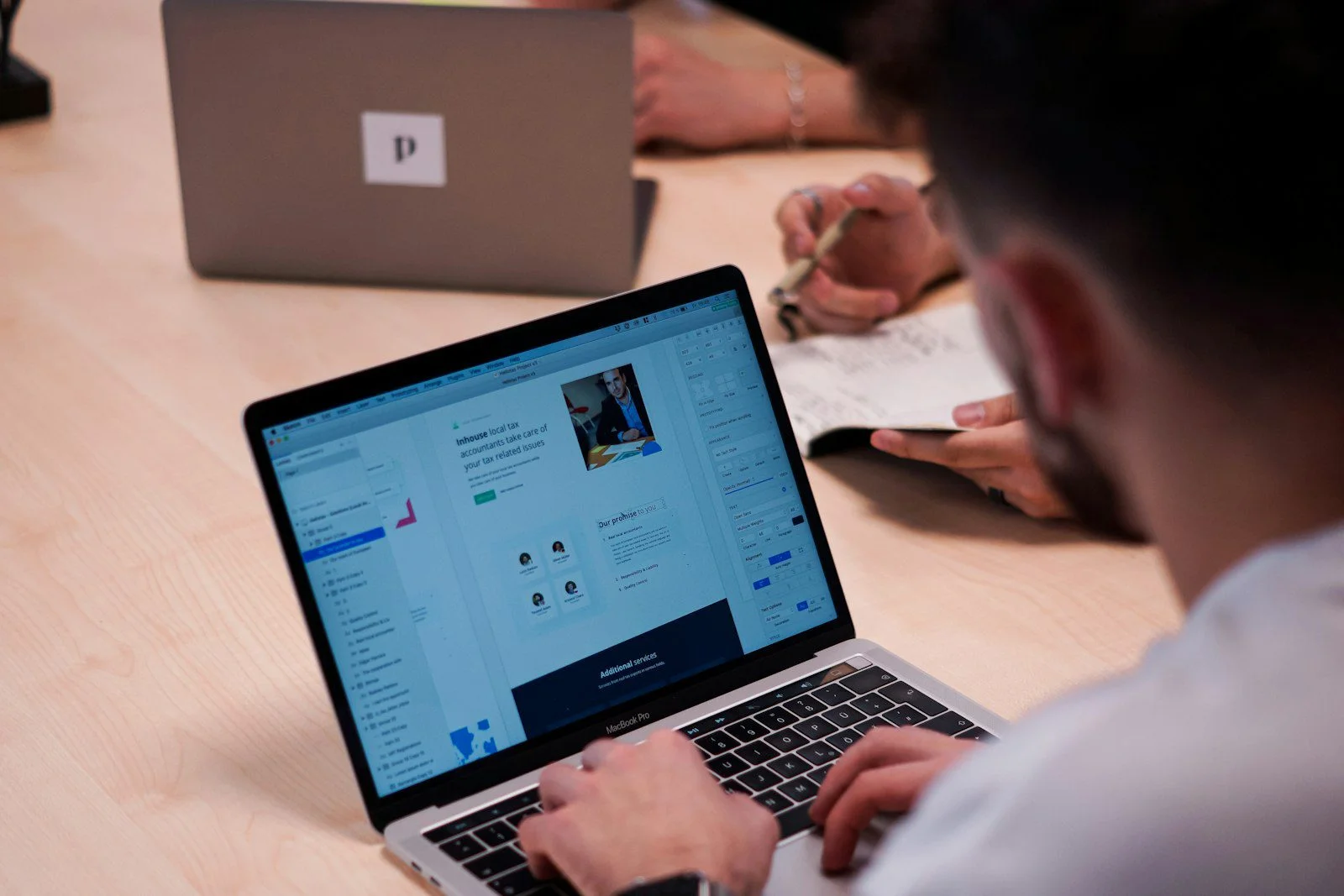 Web designer working at a laptop on a website project