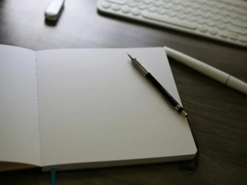Open notebook and keyboard representing conversion copywriting