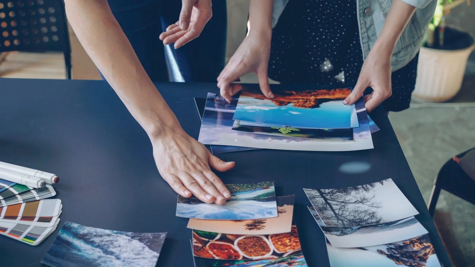 People arranging photos representing image SEO and visual content workflow