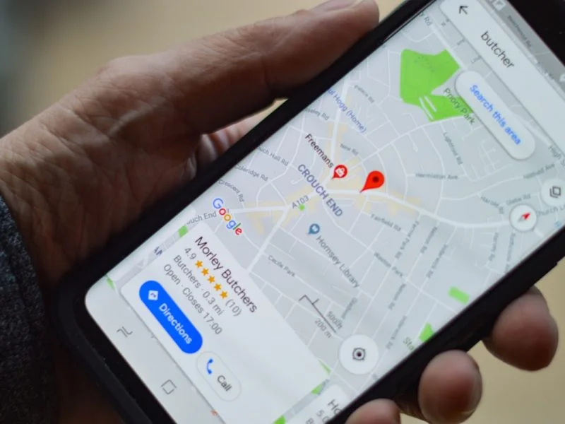 Person searching for local businesses on a smartphone map