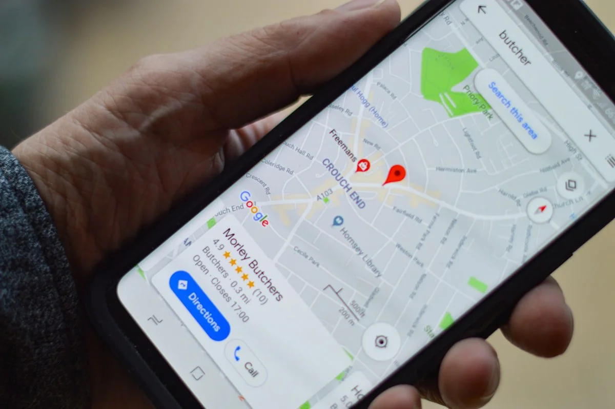 Person searching for local businesses on a smartphone map