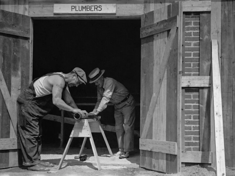 Plumber working on pipes representing local SEO for plumbing businesses