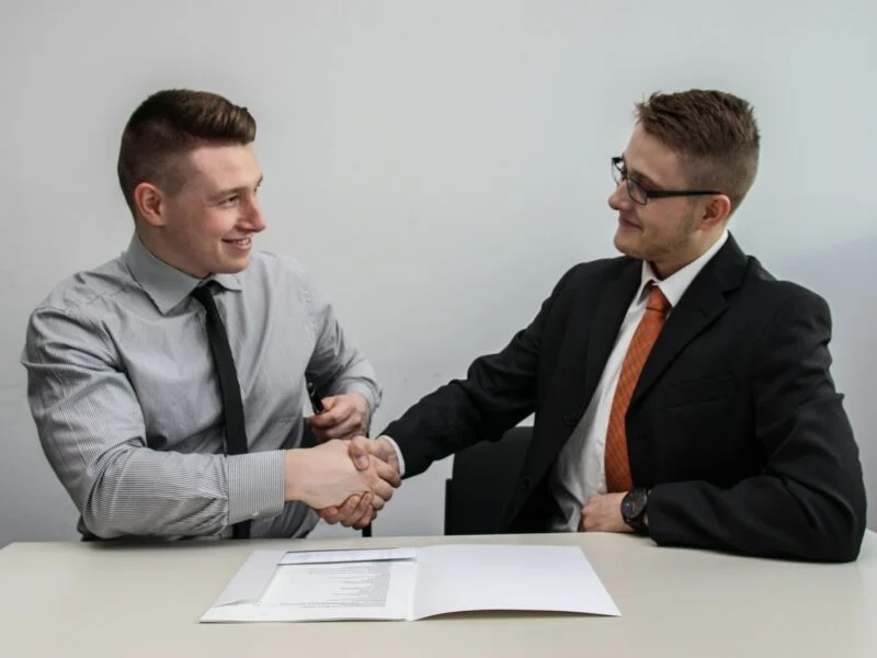 Business handshake representing trust signals on a website