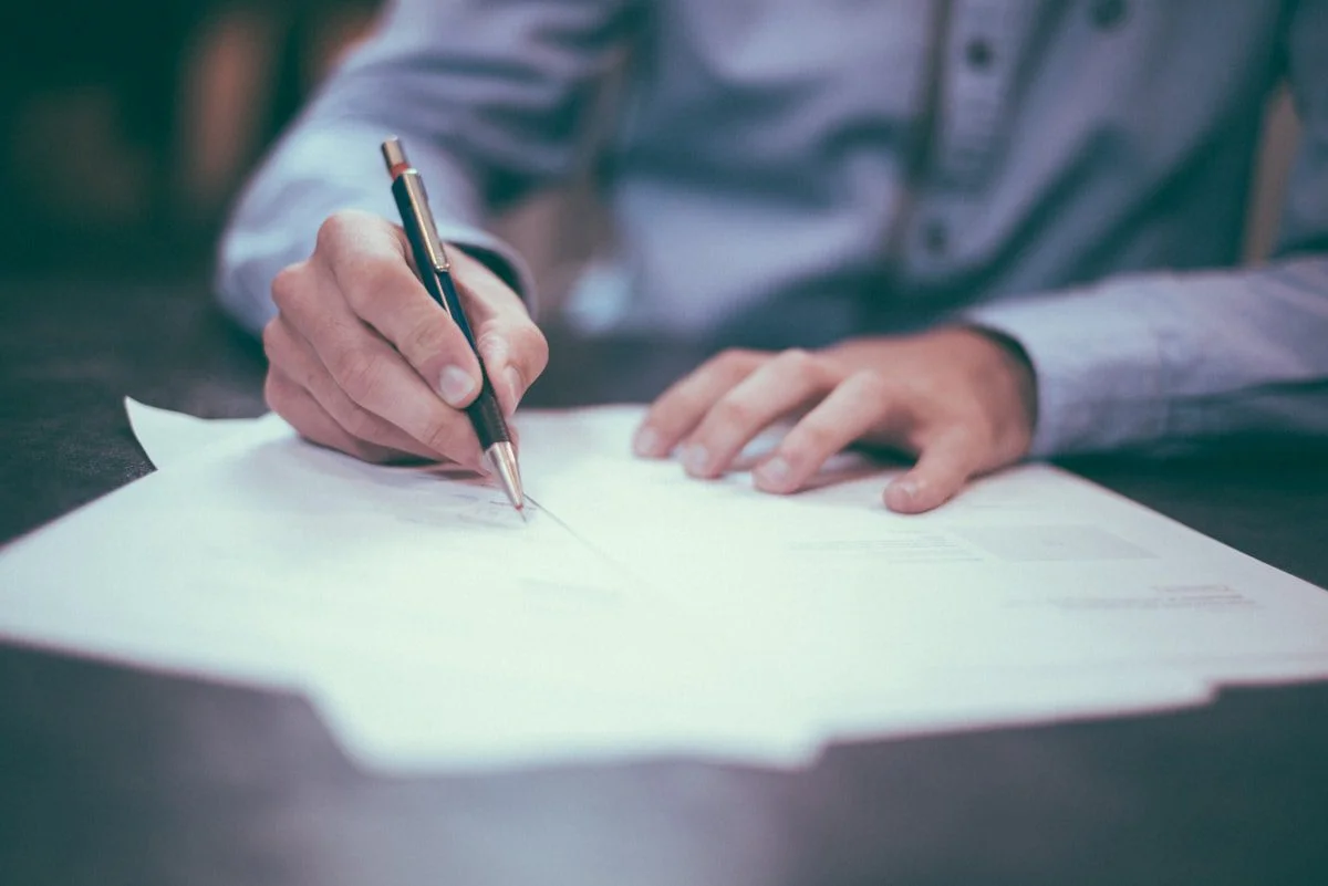 Person writing optimised meta descriptions for search results