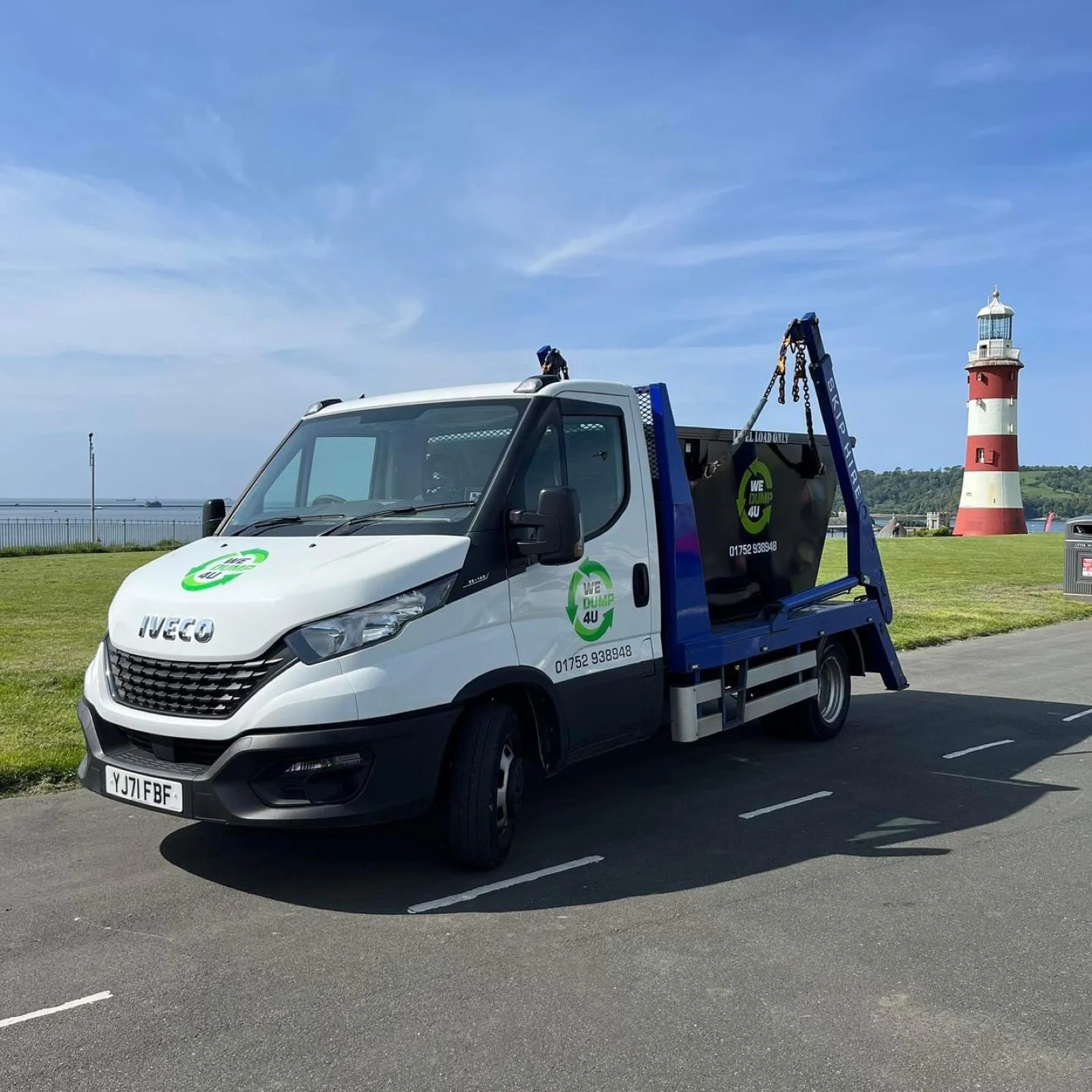 A WeDump4U skip lorry by Plymouth Hoe lighthouse