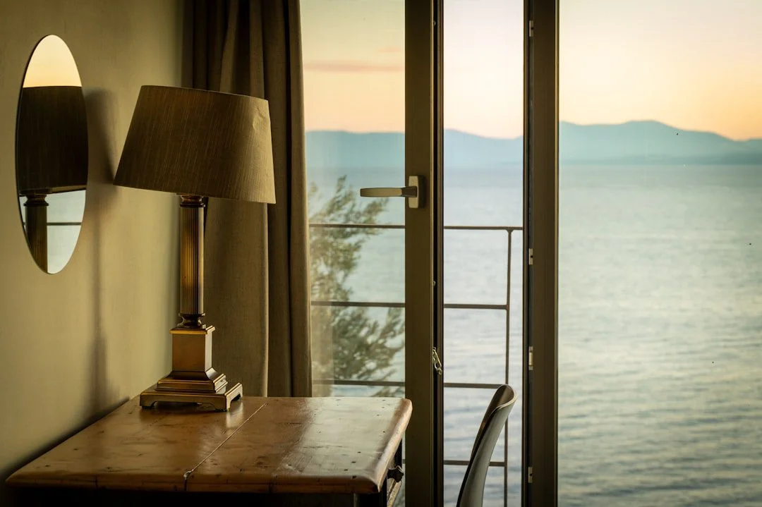 Sunlit coastal holiday let bedroom with a sea view, styled for guests booking a Sussex seaside stay