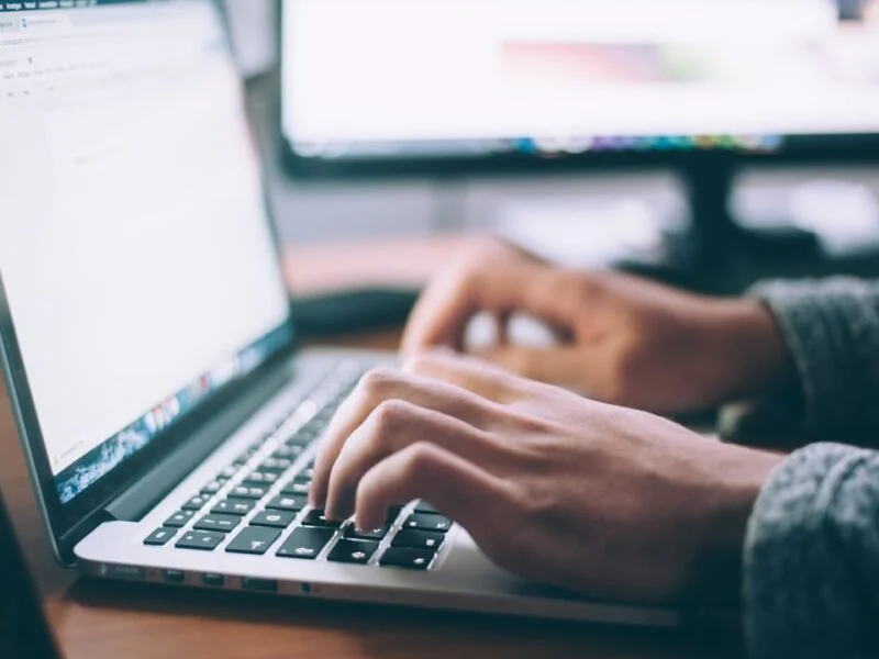 A person browsing a website using only the keyboard on a laptop in natural light