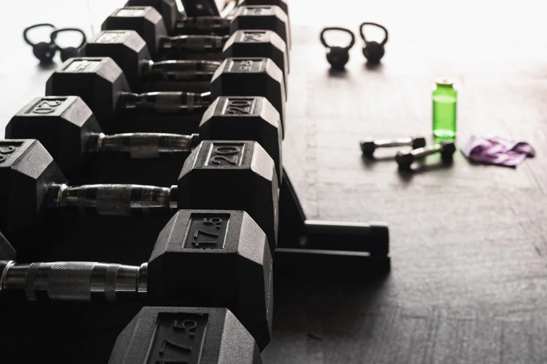 A gym member checking a class timetable on their phone inside a bright fitness studio