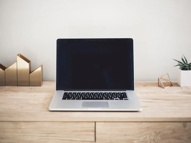 A web designer working through a pre-launch website checklist on a laptop before going live